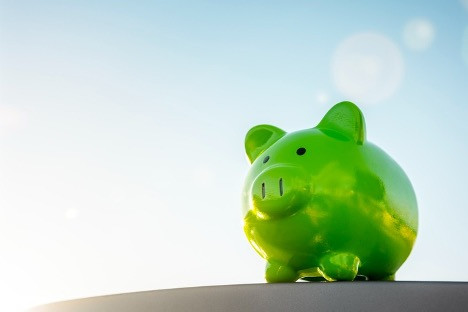 A green piggy bank, symbolizing savings and financial responsibility with an eco-friendly focus.